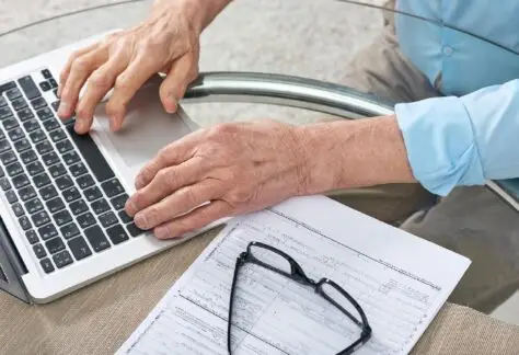 Man filling out form on computer